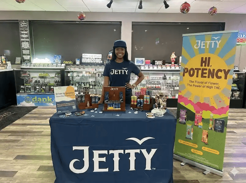 Brand ambassador at retail activation booth with product display